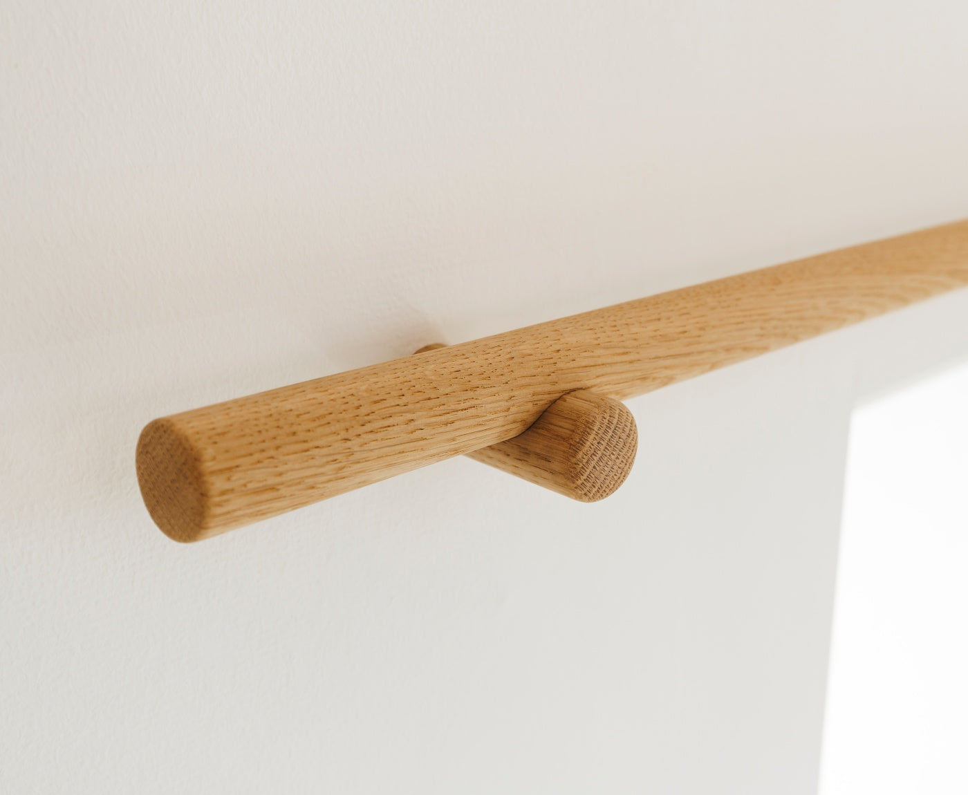 Detailbild von Ende der Gardinenstange Eiche mit Halterung aus Eiche